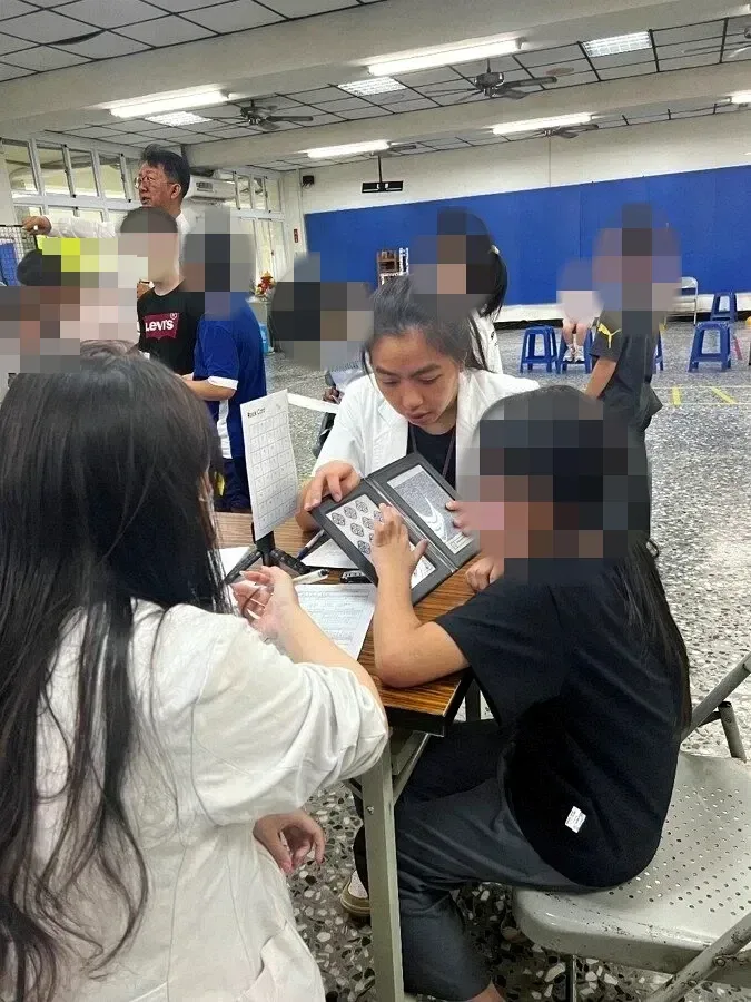 A professional uses picture cards to measure a student's visual function
